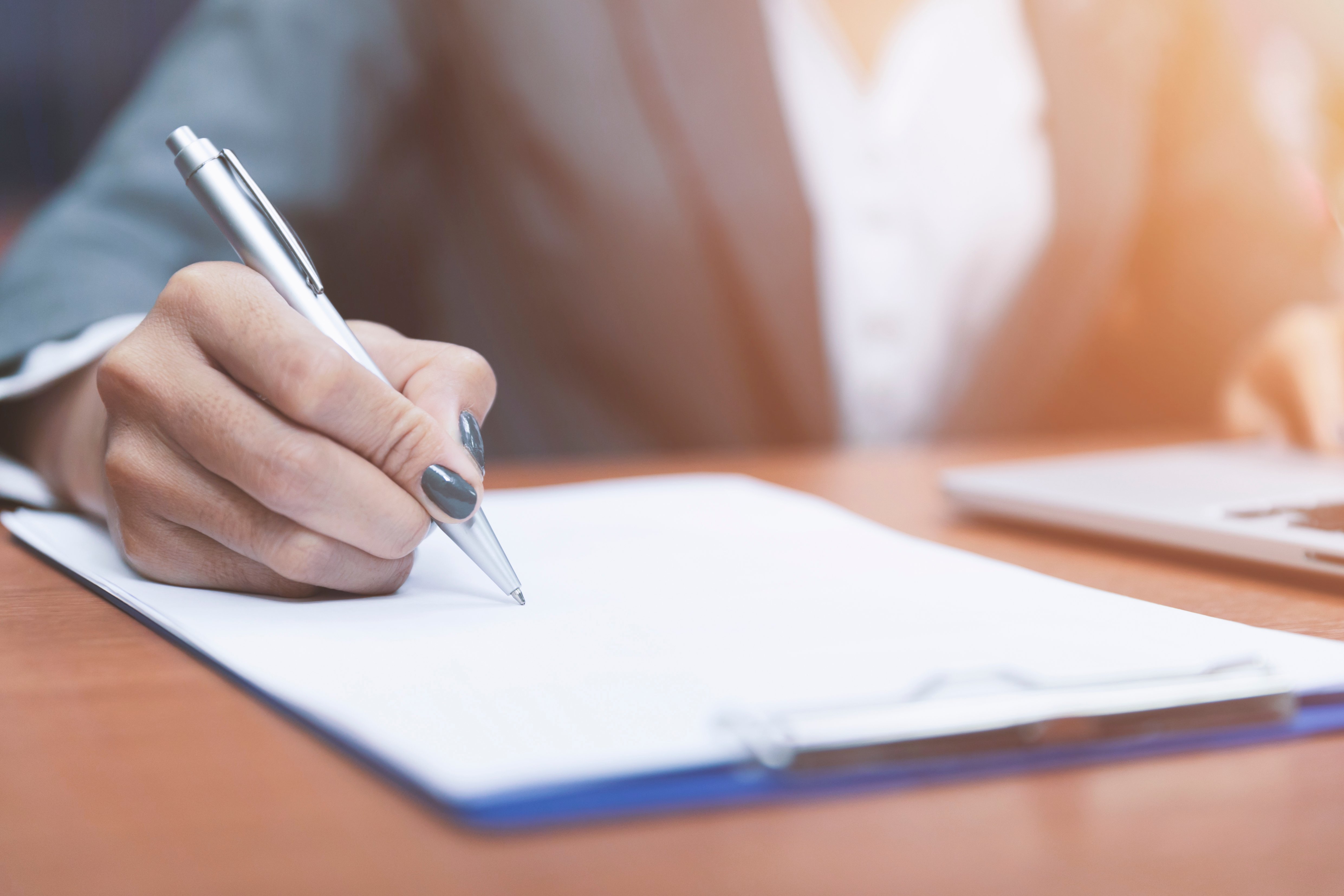 33096202-close-up-hand-of-woman-holding-pen-thinking-and-writing (1).jpg